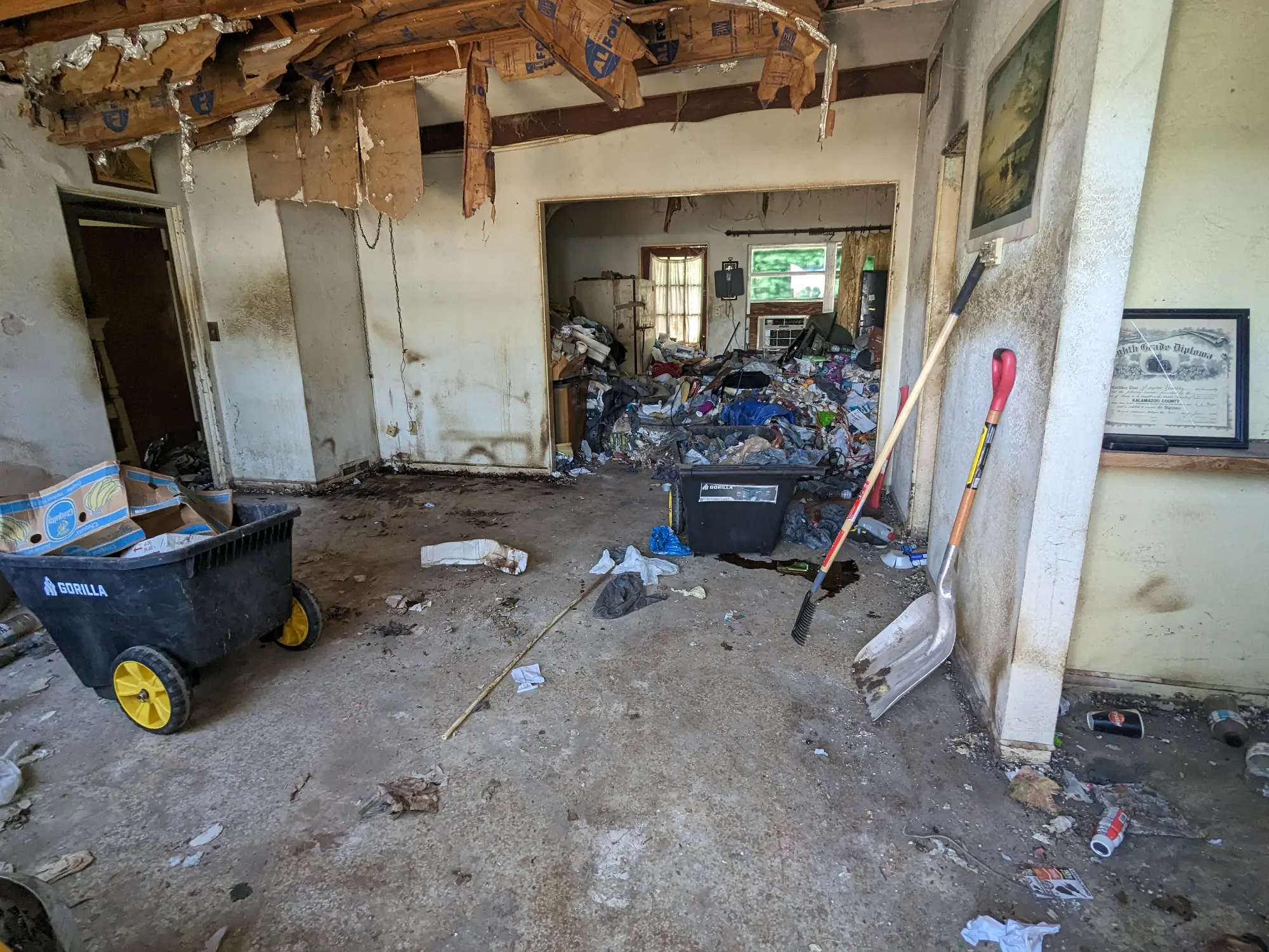 Full-house cleanout with a roll-off dumpster handling heavy household clutter
